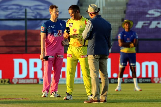 Rajasthan Royals captain Steve Smith and Chennai Super Kings captain Mahendra Singh Dhoni speak with presenter Danny Morrison at the toss before their IPL match in Sharjah on Monday.