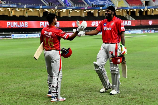 Kings XI Punjab's Mayank Agarwal and Chris Gayle celebrate the win against the Mumbai Indians at the Dubai International Cricket Stadium