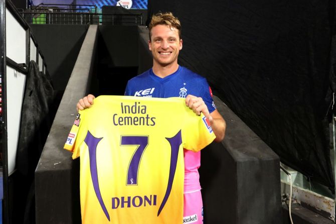 Rajasthan Royals' Jos Buttler poses with CSK captain Mahendra Singh Dhoni's jersey after the match on Monday.
