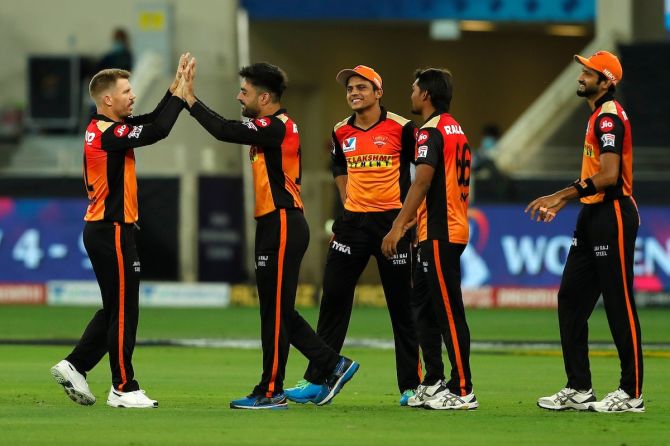 Sunrisers Hyderabad spinner Rashid Khan celebrates with skipper David Warner after taking the wicket of Chris Gayle