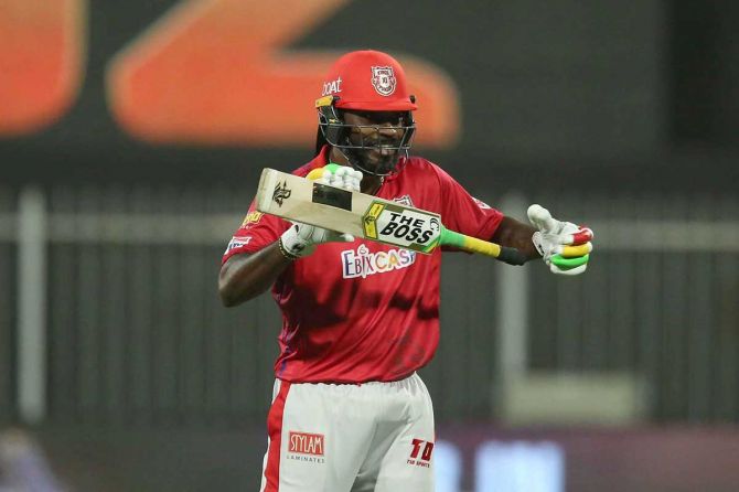 Chris Gayle of Kings XI Punjab raises his bat after scoring a fifty against the Kolkata Knight Riders at the Sharjah Cricket Stadium