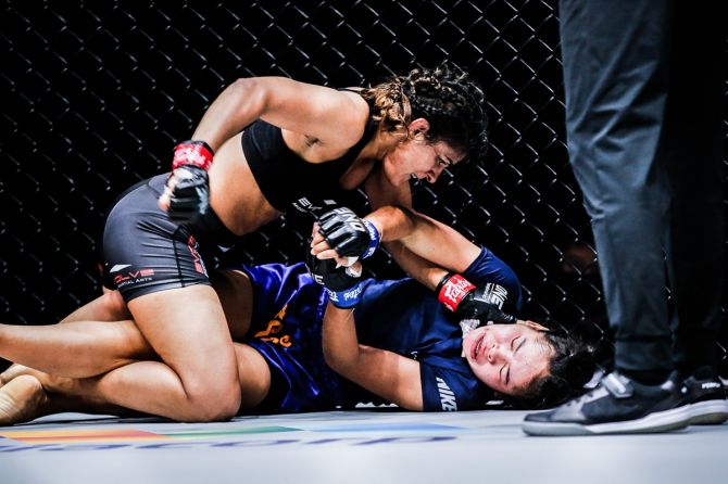 India's Ritu Phogat gets into a dominant position during her MMA Championship bout against Cambodia's Nou Srey Pov in Singapore
