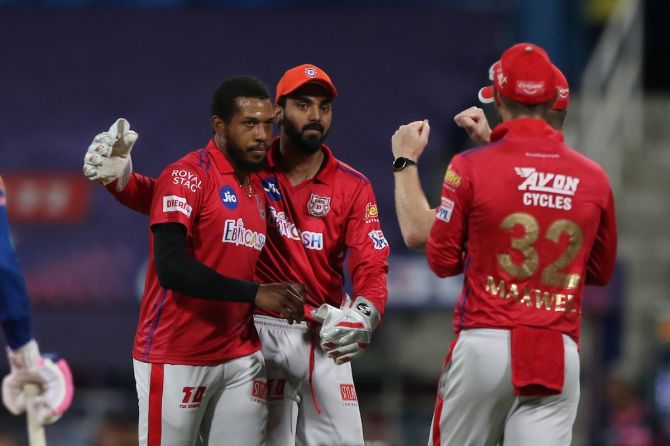 Kings XI Punjab pacer Chris Jordan is congratulated by skipper K L Rahul and teammates after dismissing Rajasthan Royals batsman Ben Stokes during the IPL match in Abu Dhabi on Friday