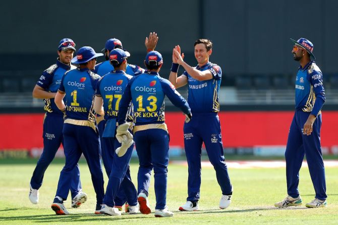 Trent Boult is congratulated by his Mumbai Indians teammates as he celebrates the wicket of Shikhar Dhawan