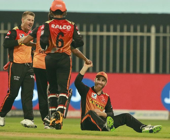 SunRisers Hyderabad players celebrate after Kane Williamson, on the ground, catches Virat Kohli off the bowling of Sandeep Sharma.