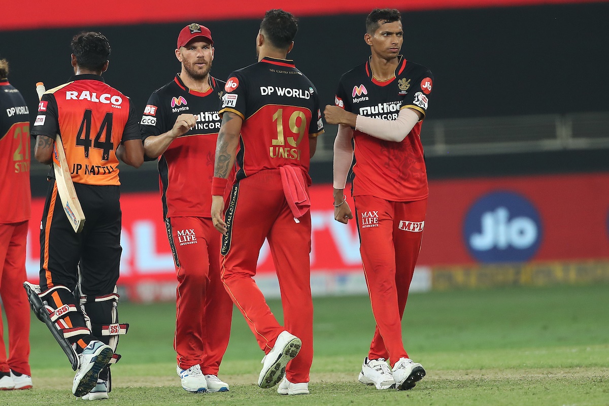 Royal Challengers Bangalore players Aaron Finch, Umesh Yadav and Navdeep Saini celebrate victory over SunRisers Hyderabad in the IPL match in Dubai on Monday.
