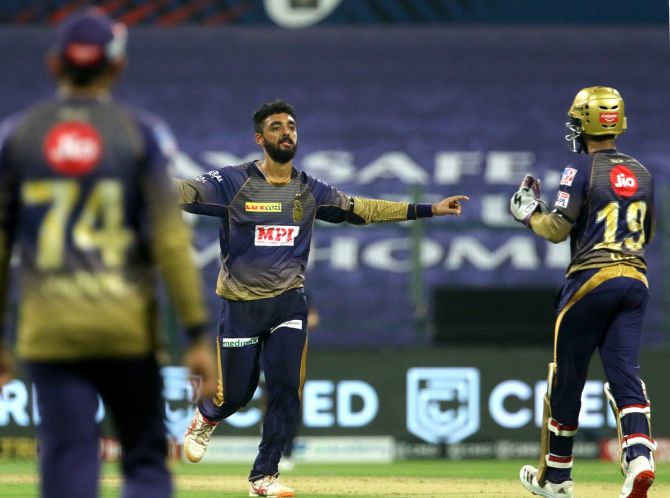 Varun Chakravarthy celebrates dismissing David Warner caught and bowled