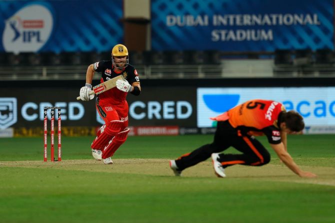 SunRisers Hyderabad bowler Mitchell Marsh slips and twists his ankle while attempting to cut off a run during in the IPL season opener against Royal Challengers Bangalore, Dubai.