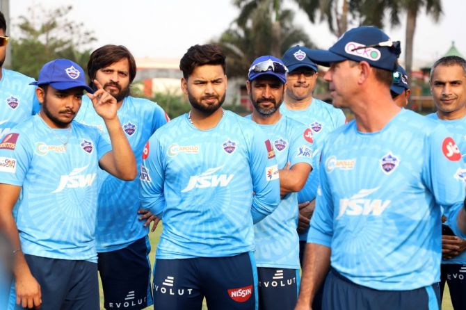 Delhi Capitals' players listen intently to coach Ricky Ponting speak at a team training session on Friday