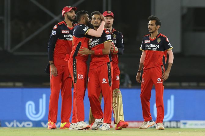 Harshal Patel is congratulated by his Royal Challengers Bangalore teammates after dismissing Marcus Stoinis in the IPL match against Delhi Capitals in Ahmedabad on Tuesday.