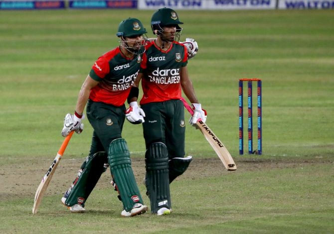 Afif Hossain and Nurul Hasan celebrate as they walk back after guiding Bangladesh to victory over Australia in the second T20I in Dhaka on Wednesday.