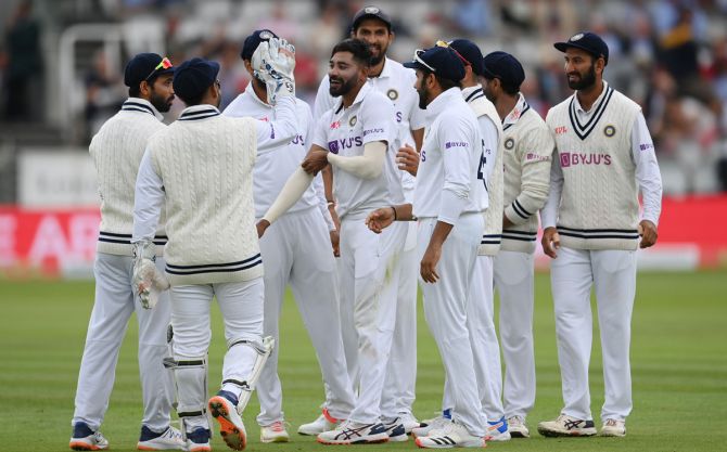 Mohammed Siraj celebrates with teammates after dismissing Dominic Sibley and Haseeb Hameed off successive deliveries.