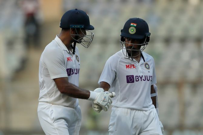 Mayank Agarwal is congratulated by Wriddhiman Saha on his unbeaten hundred as they walk back at the end of play on Day 1 in the second Test.
