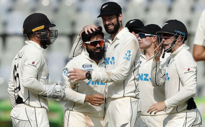 Ajaz Patel celebrates with his teammates after dismissing Cheteshwar Pujara for a duck