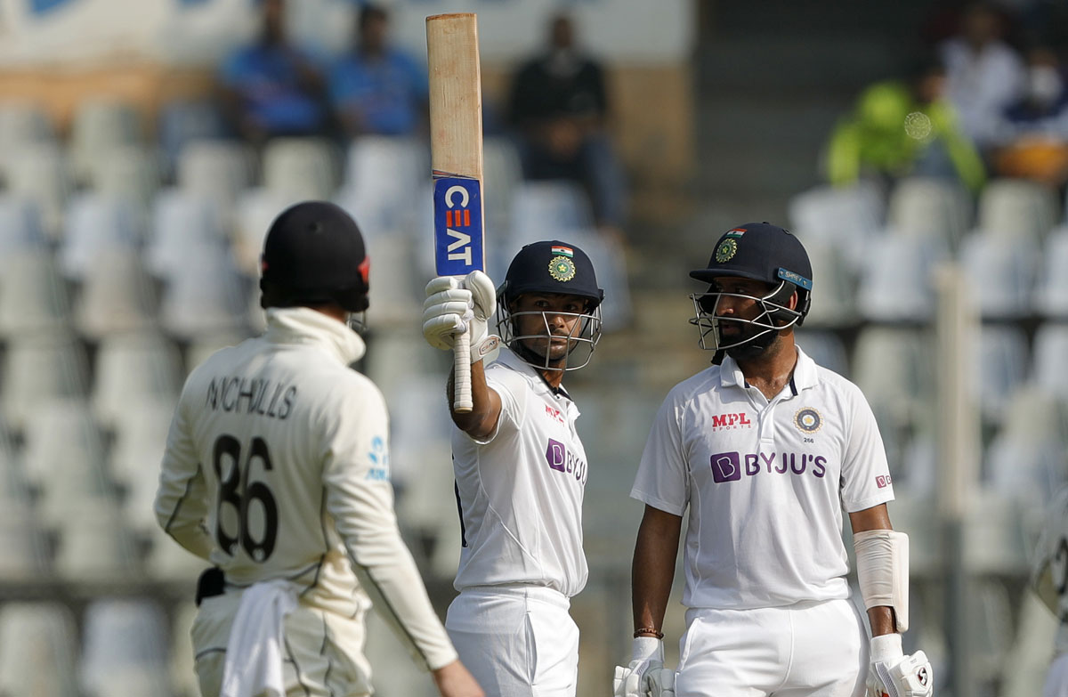 Mayank Agarwal celebrates after completing a half-century on Day 3 of the second Test against New Zealand, in Mumbai, on Sunday.