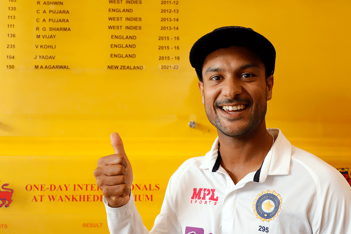 India's Mayank Agarwal is elated as his name gets inscribed on the Honours Board at the Wankhede Stadium, in Mumbai on Monday. He scored 150 and 62 in each innings of the Test match. 