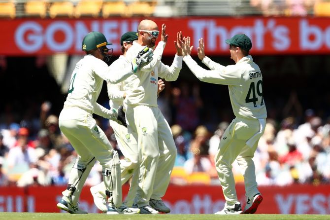 Australia's off-spinner Nathan Lyon celebrates taking the wicket of England's Ollie Pope during Day 4 of the first Ashes Test, at The Gabba in Brisbane, on Saturday.