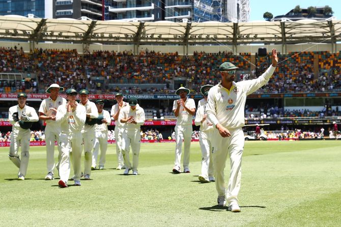 Australia's Nathan Lyon waves to the crowd at the lunch break after taking four wickets in England's second innings during Day 4 of the first Ashes Test, at The Gabba in Brisbane, on Saturday.
