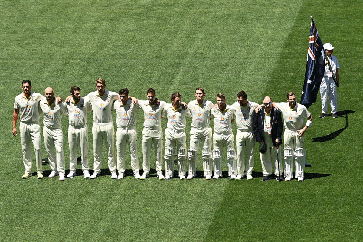 Australian players stand during the signing of the National Anthem before day one of the Second Ashes Test match at the Adelaide Oval in Adelaide on Thursday