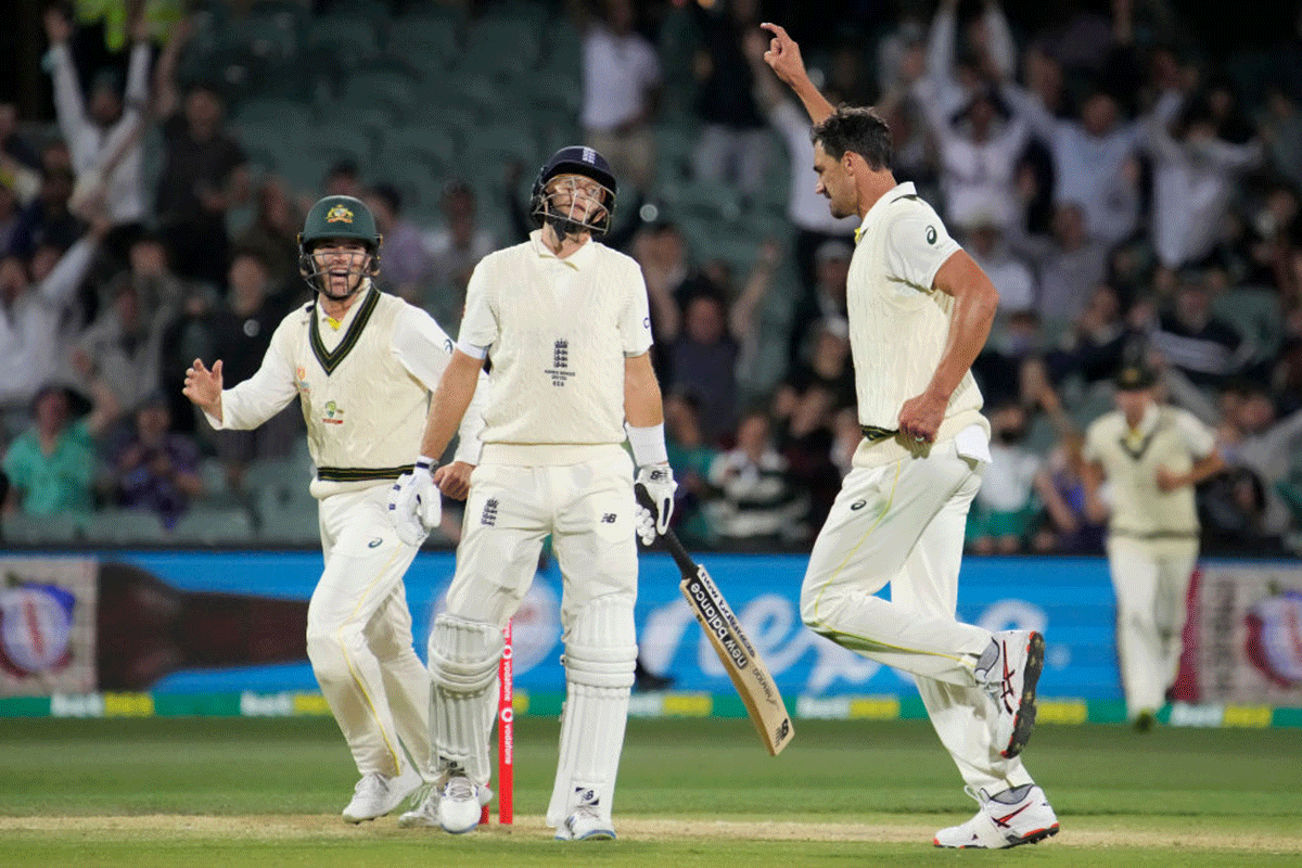 Australia's Mitchell Starc celebrates on taking out England's Joe Root for 24 runs, just before stumps