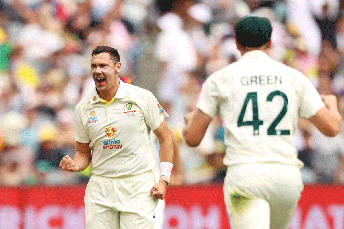 Australia's Scott Boland takes his first Test wicket by dismissing England's Mark Wood on Day 1 of the 3rd Ashes Test at Melbourne Cricket Ground on Sunday