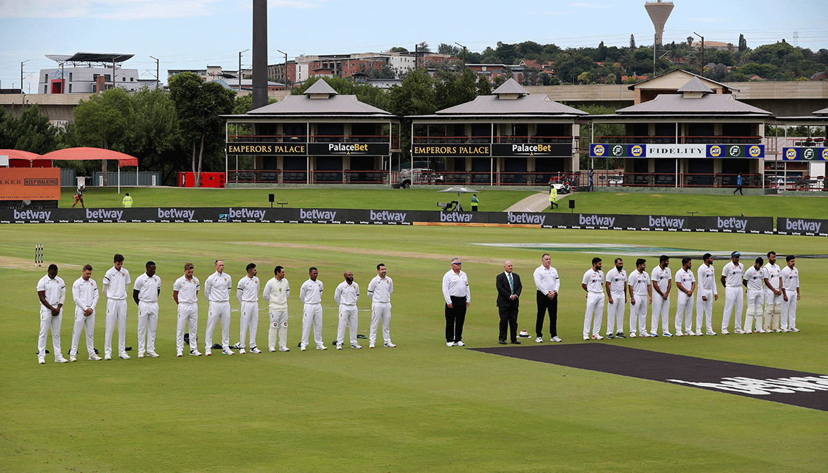 Players and officials during a moment of silence for the passing of Archbishop Desmond Tutu before the start of play on Day 1 of the 1st Test at Centurion on Sunday 