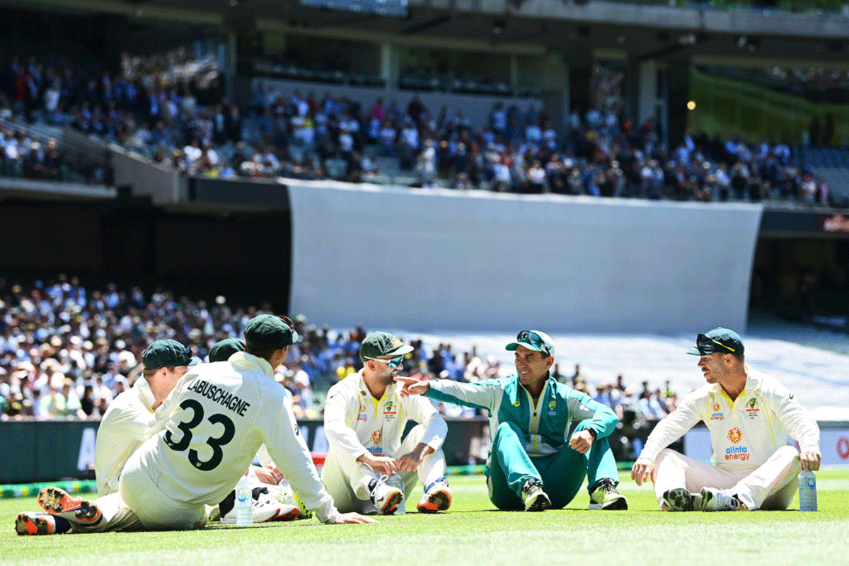 Steve Smith, Marnus Labuschagne, Alex Carey, Nathan Lyon, Australia coach Justin Langer and David Warner are seen chatting after retaining the Ashes on day three of the Third Ashes Test at Melbourne Cricket Ground on Tuesday