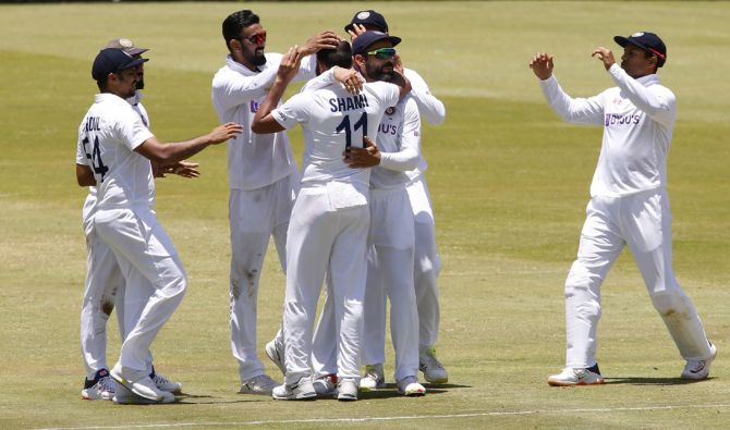 Mohammed Shami celebrates with teammates after taking the wicket of South Africa's Wiaan Mulder