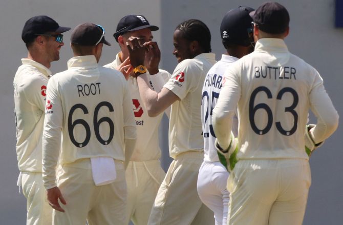 Jofra Archer is congratulated by his England teammates after dismissing Shubman Gill