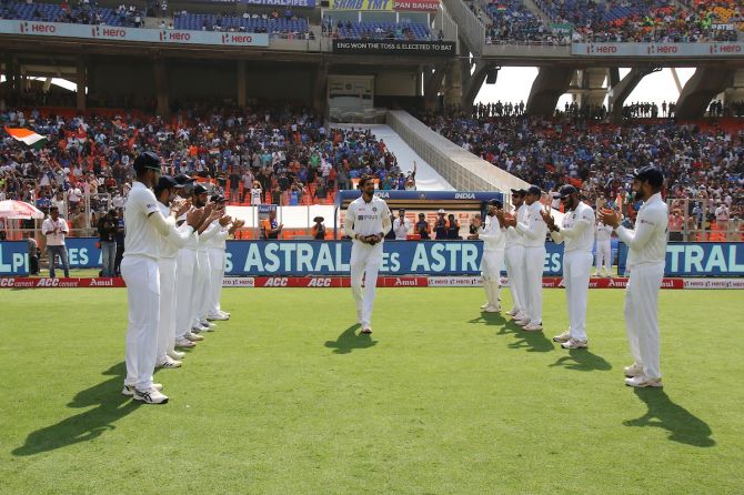 Pacer Ishant Sharma, playing his 100th Test, is given a guard of honour by his India teammates before the start of play in the third Test against England, at the Narendra Modi stadium , in Ahmedabad, on Wednesday. 