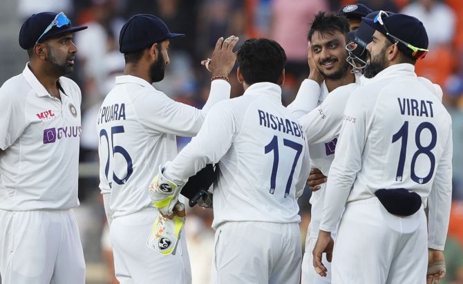 India's players rejoice after Joe Root is dismissed