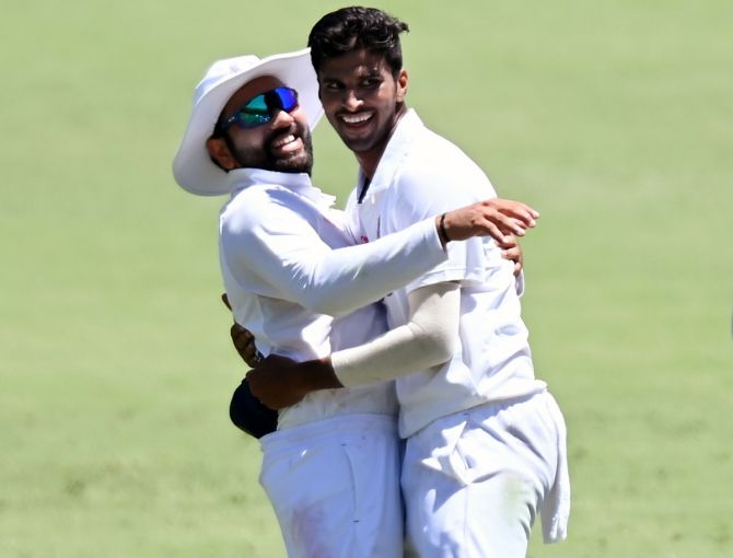 Washington Sundar celebrates with Rohit Sharma after dismissing Steve Smith during Day 1 of the fourth Test against Australia, at the Gabba, in Brisbane, on Friday.
