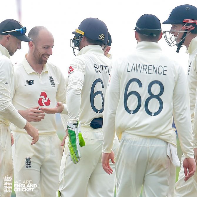England's Jack Leash celebrates with teammates on claiming five wickets in the opening Test in Galle on Sunday