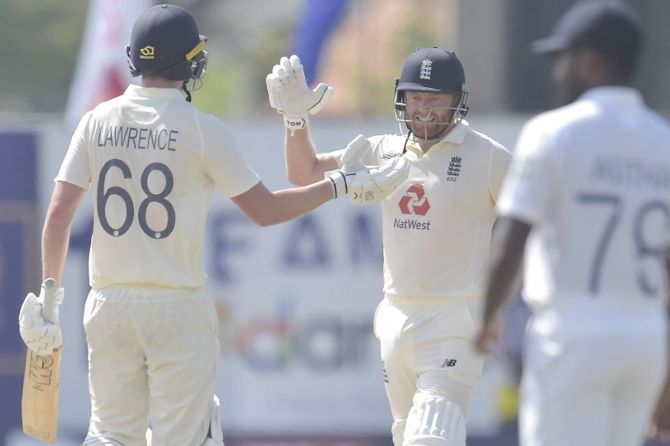 England’s Jonny Bairstow and debutant Dan Lawrence celebrate after knocking off the required runs to win the first Test against Sri Lanka, in Galle, on Monday