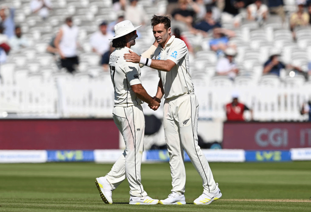 New Zealand's Tim Southee is congratulated by teammate Colin de Grandhomme after taking 6 wickets on Day 4 of the First Test against England at Lord's Cricket Ground in London on Saturday