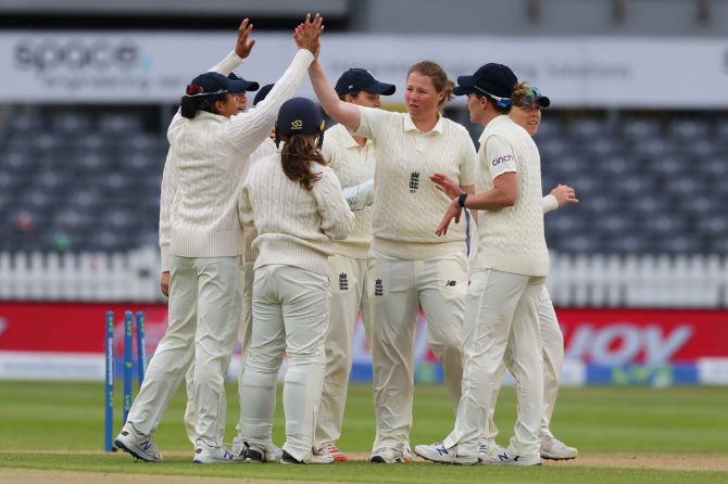 England's players celebrate at the fall of the last wicket in India's first innings on Day 3 of the one-off women's Test, at Bristol County Ground on Friday