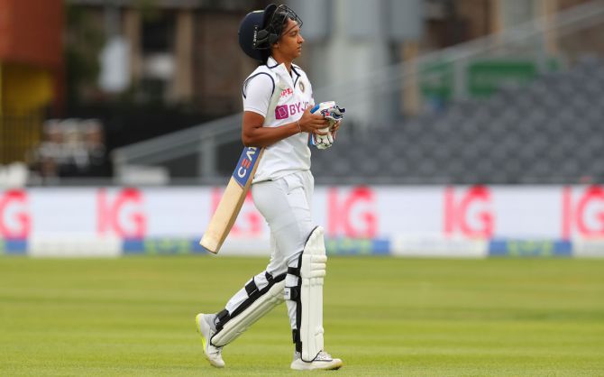 Harmanpreet Kaur walks back after being dismissed by Sophie Ecclestone in the first innings 