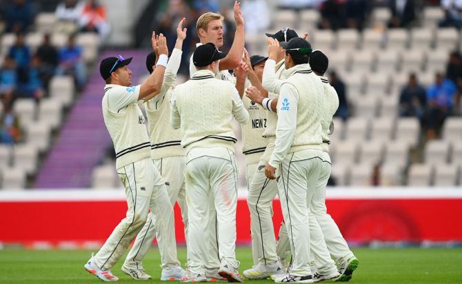 Kyle Jamieson celebrates with teammates after dismissing Rohit Sharma