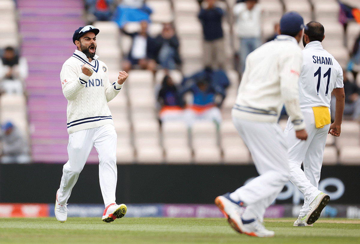 India's captain Virat Kohli celebrates the wicket of New Zealand's Ross Taylor after he is dismissed by Mohammed Shami 