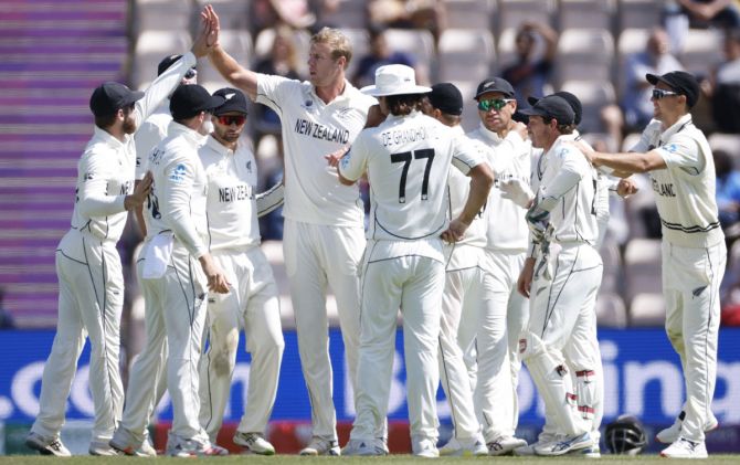 New Zealand's Kyle Jamieson celebrates with teammates after taking the wicket of India's Virat Kohli