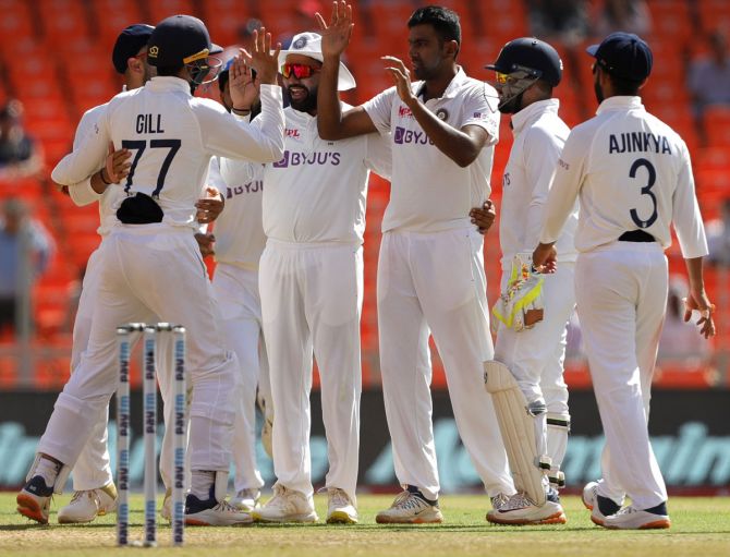 Ravichandran Ashwin celebrates with his India teammates after dismissing Ollie Pope