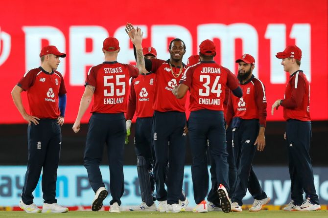 England pacer Jofra Archer celebrates with teammates after dismissing India opener Rohit Sharma during the fourth T20I, in Ahmedabad, on Thursday.