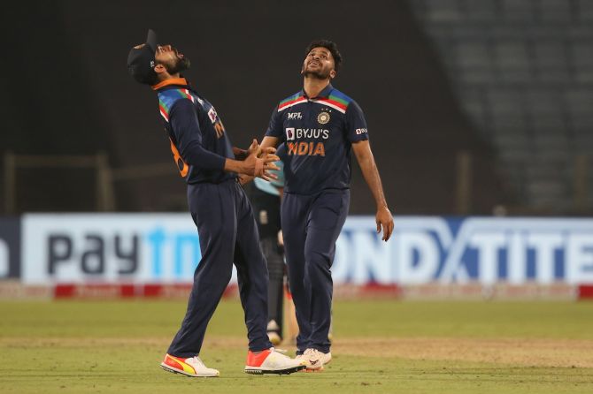 Virat Kohli and Shardul Thakur celebrate the wicket of England's Liam Livingstone the third One-Day International against England, in Pune, on Sunday. 
