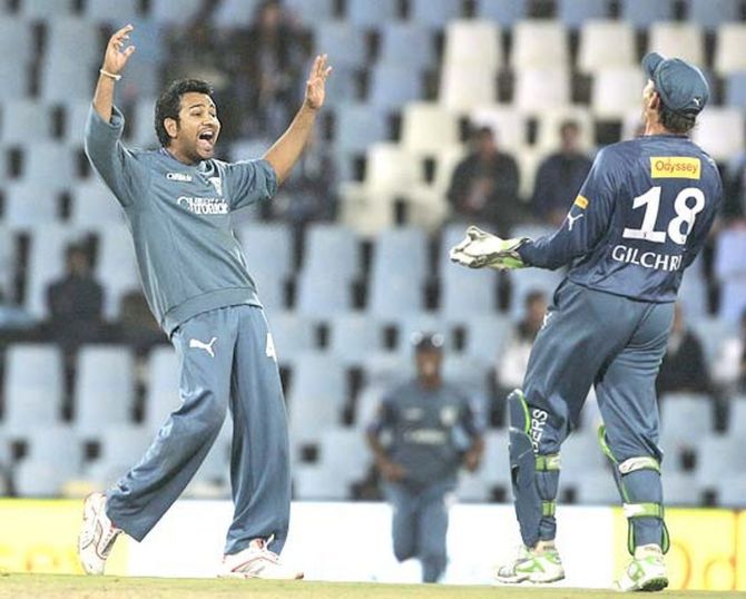 Deccan Chargers' Rohit Sharma celebrates with captain Adam Gilchrist after taking the wicket of JP Duminy  