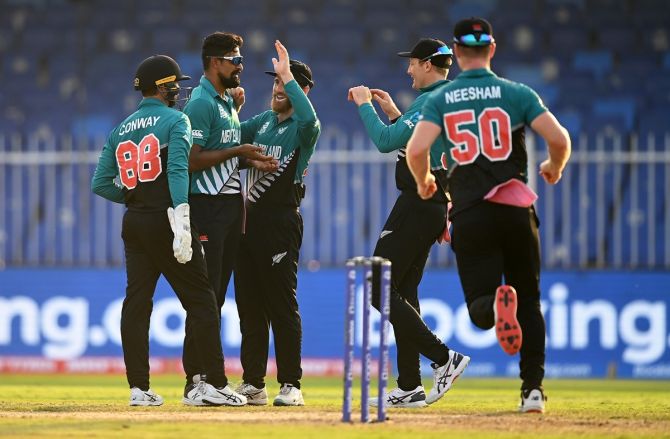 New Zealand spinner Ish Sodhi is congratulated by skipper Kane Williamson and teammates after dismissing Namibia's Gerhard Erasmus during the T20 World Cup match, at Sharjah Cricket Stadium, on Friday.