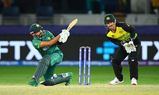 Australia's wicketkeeper Matthew Wade watches as Pakistan opener Babar Azam fires the ball to the boundary during the second T20 World Cup semi-final, in Dubai, on Thursday.