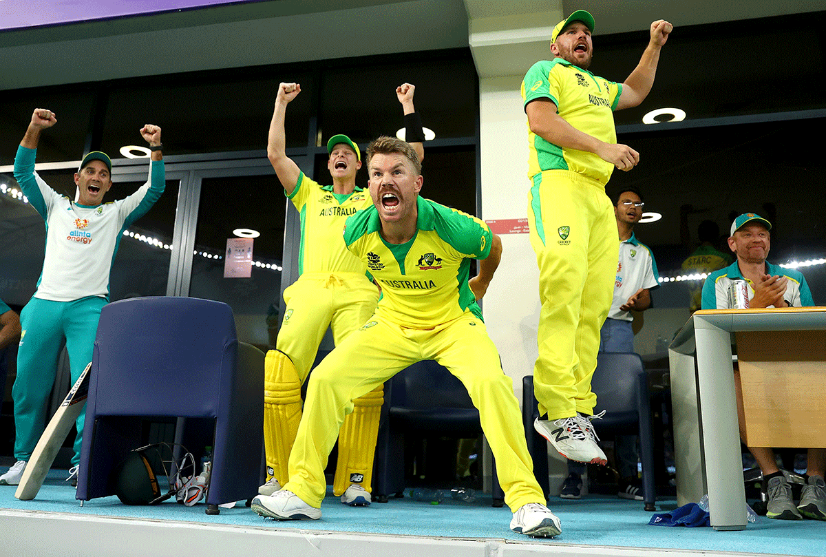 Australian coach Justin Langer celebrate with Steve Smith, David Warner and Aaron Finch celebrate after winning the T20 World Cup final on Sunday
