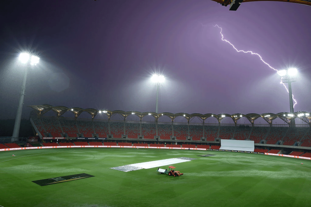 Lightning is seen during a rain delay on day two of the Test match between Australia and India at Metricon Stadium in Gold Coast on Friday