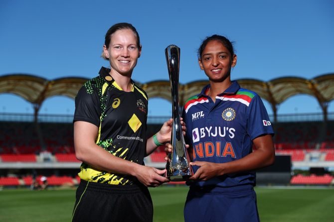 Australia's Meg Lanning and India's Harmanpreet Kaur pose with the series trophy ahead of the T20 International series, at Metricon Stadium in Gold Coast, Australia, on Wednesday