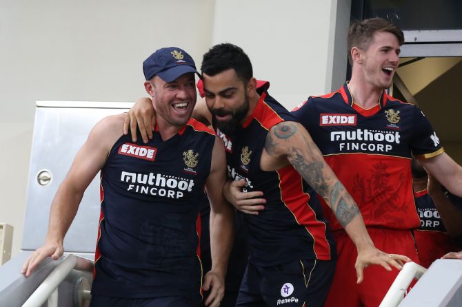 Royal Challengers Bangalore captain Virat Kohli celebrates with AB de Villiers after victory over Delhi Capitals in the Indian Premier League match, in Dubai, on Friday.